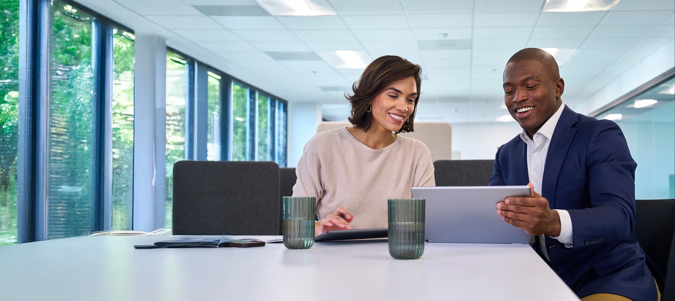 man and woman looking at computer screen and smiling