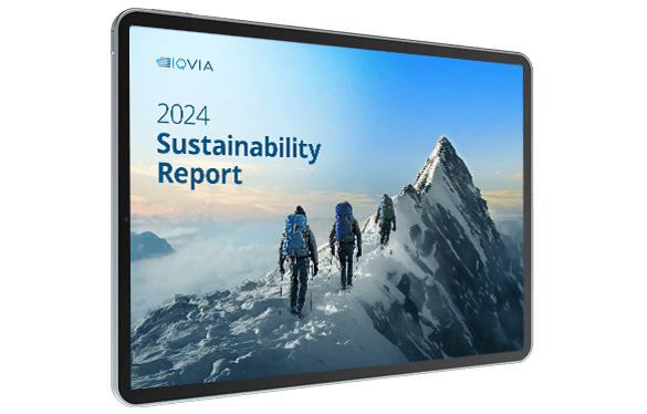 Tablet screen showing an IQVIA cover titled "2024 Sustainability Report" depicting three climbers walking along a snowy mountain ridge toward a peak under a blue sky.